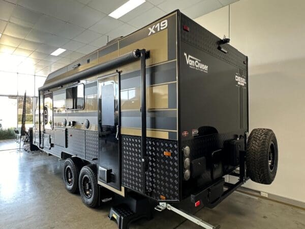  this 19-foot marvel ensures you have all the comforts of home while on the road.<br /><br />Key Specifications:<br />Chassis: Built on a formidable 3.5-tonne hot-dip galvanized chassis with a D035 Coupling and Extended A-Frame for secure towing.<br />Suspension: Cruisemaster XT coil spring suspension for smooth rides across tough terrains.<br />Weight: Tare Weight of 2793 kg and ATM Weight of 3500 kg.<br />Ball Weight: 182 kg.<br />Exterior Features:<br />Construction: Sleek Aluminium Composite Panels with high checker plate sides.<br />Awning: 14ft black roll-out awning to extend your living space.<br />Toolbox: Equipped with a robust toolbox and ample storage solutions.<br />Tyres: MPC Tracmax Tyres for reliable performance.<br />Interior Features:<br />Comfort: Queen Size Innerspring Pillowtop Mattress for restful slumber.<br /><br />Luxury: Acacia solid timber benchtops